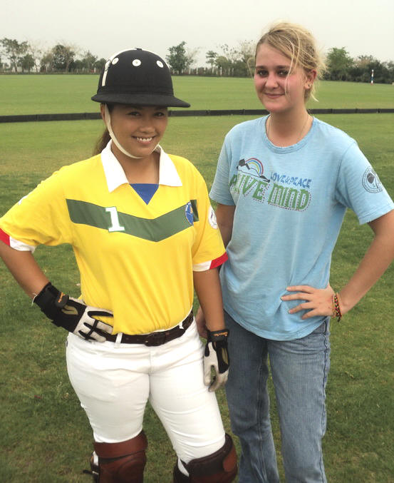 Ploy showing Melissa the correct standing position at the field